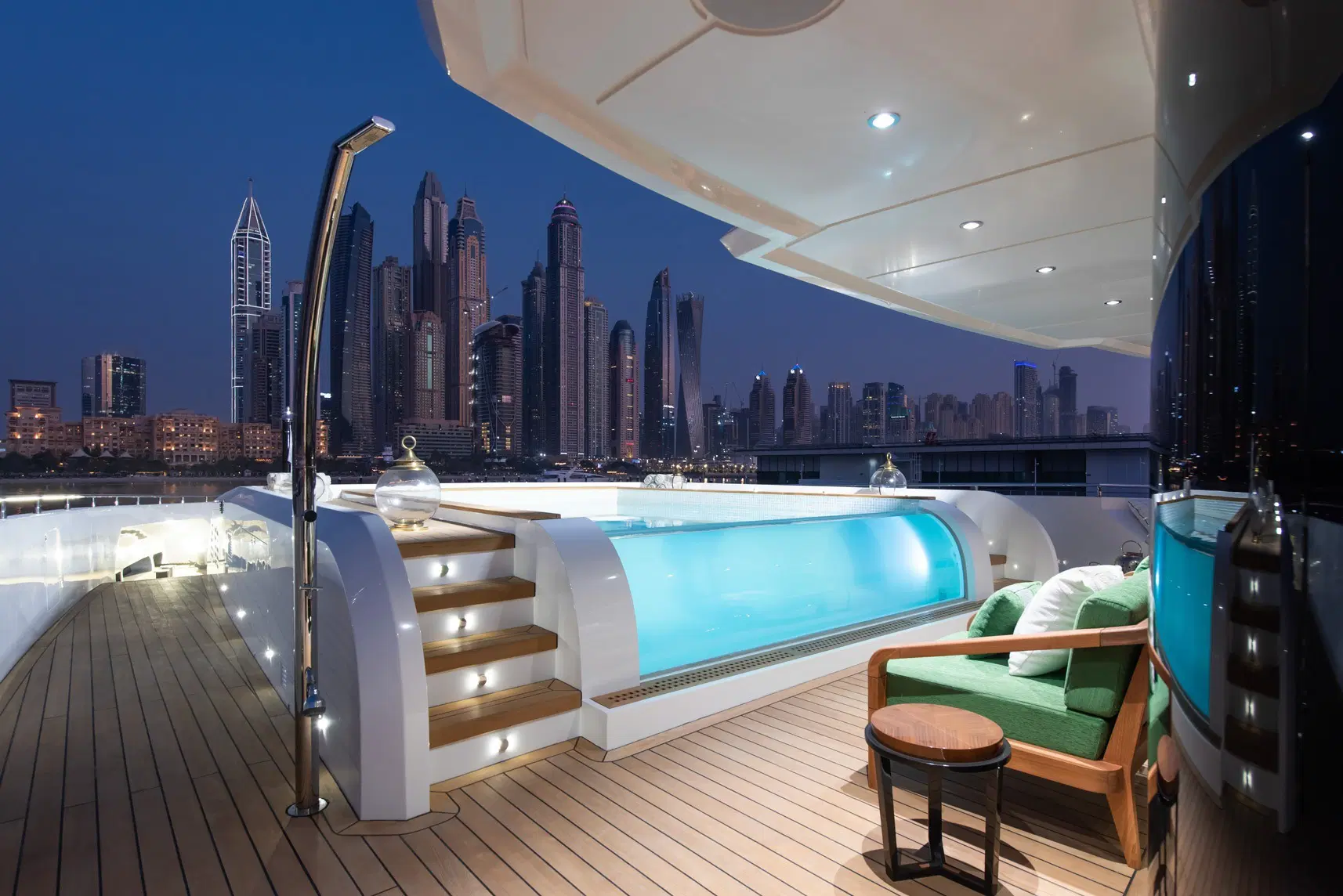 The Majesty 175 owner's deck infinity pool at night, Dubai Marina skyline behind