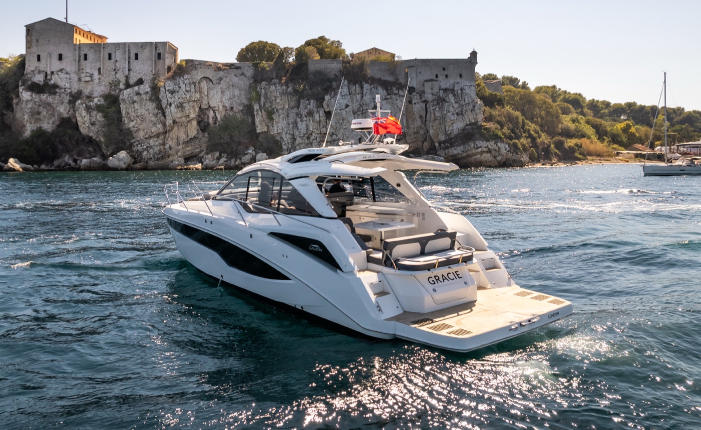 405 HTS stern view at anchor below a clifftop fortress