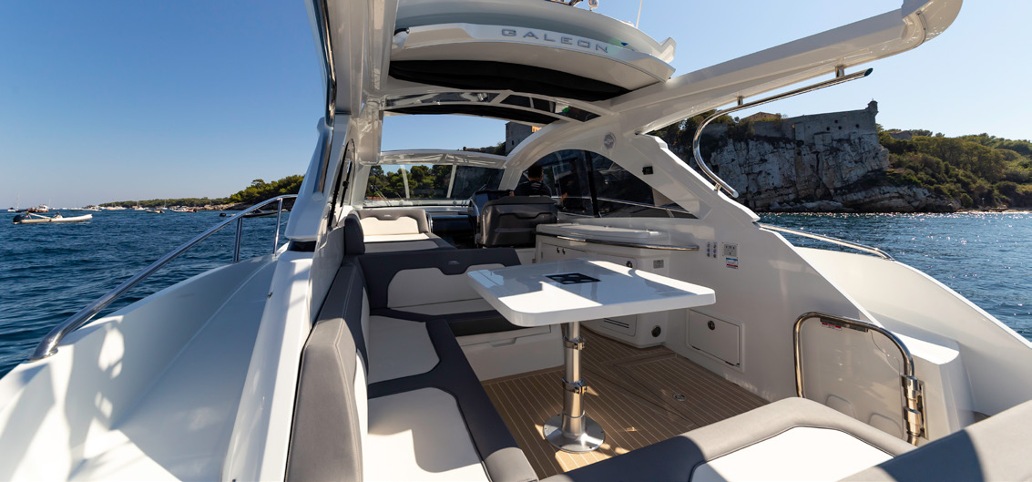 The 405 HTS cockpit with U-shaped seating and table under the hardtop