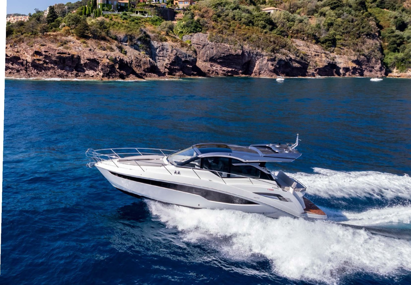 425 HTS cruising along a rocky coastline