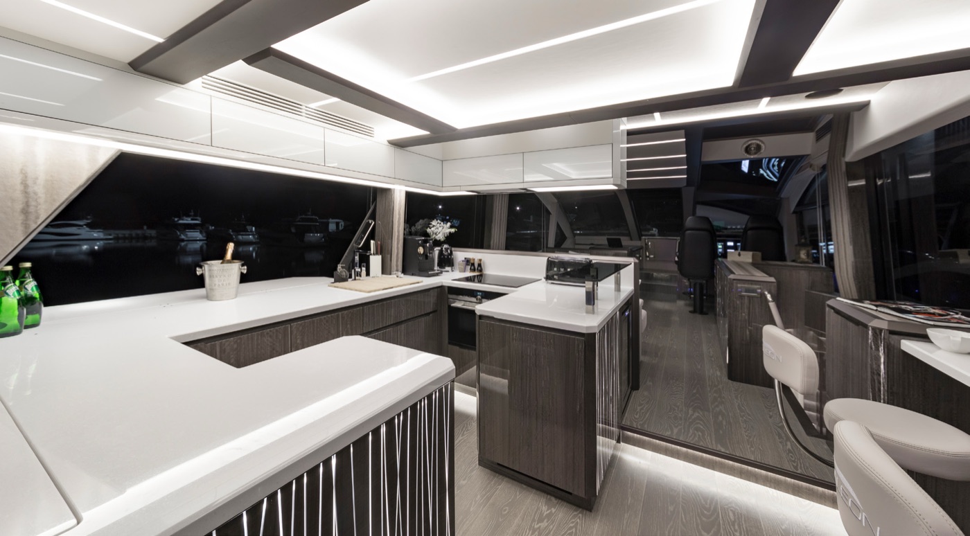 The 650 SKY galley and salon by night, in open-plan layout