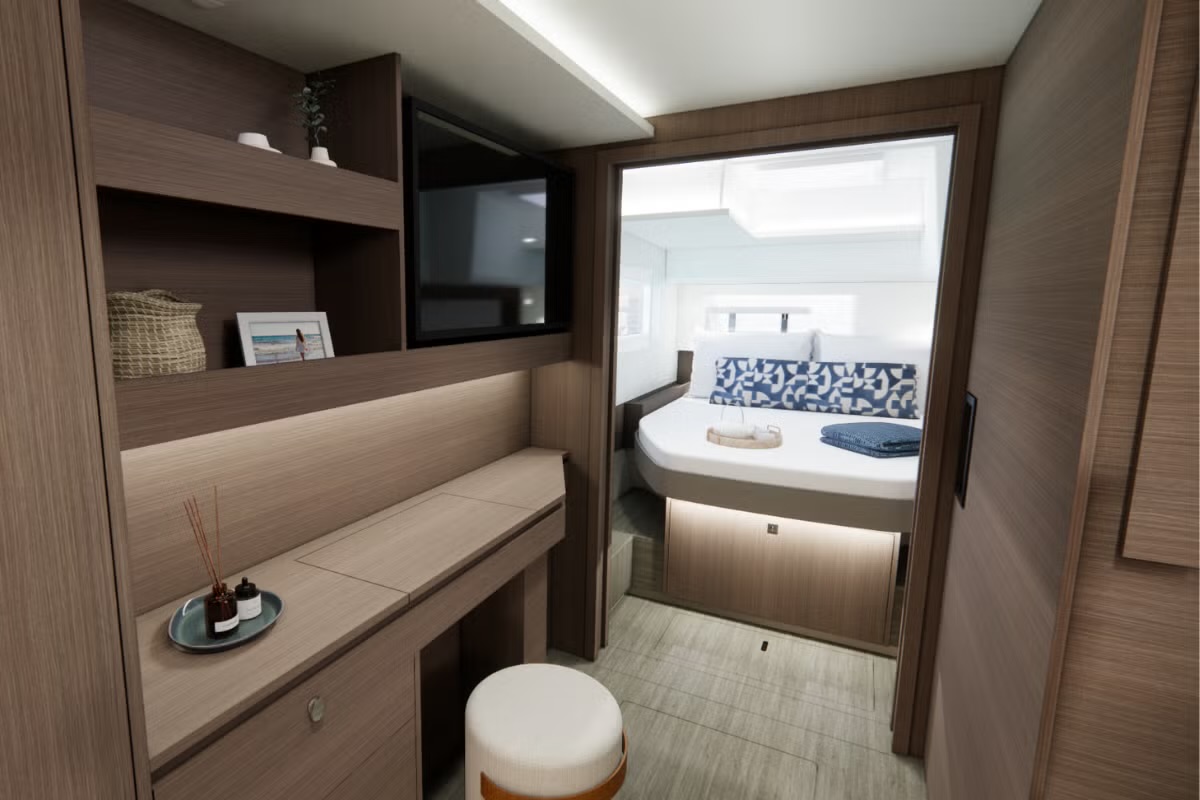 Owner's hull suite: desk, vanity and TV, looking toward the island berth