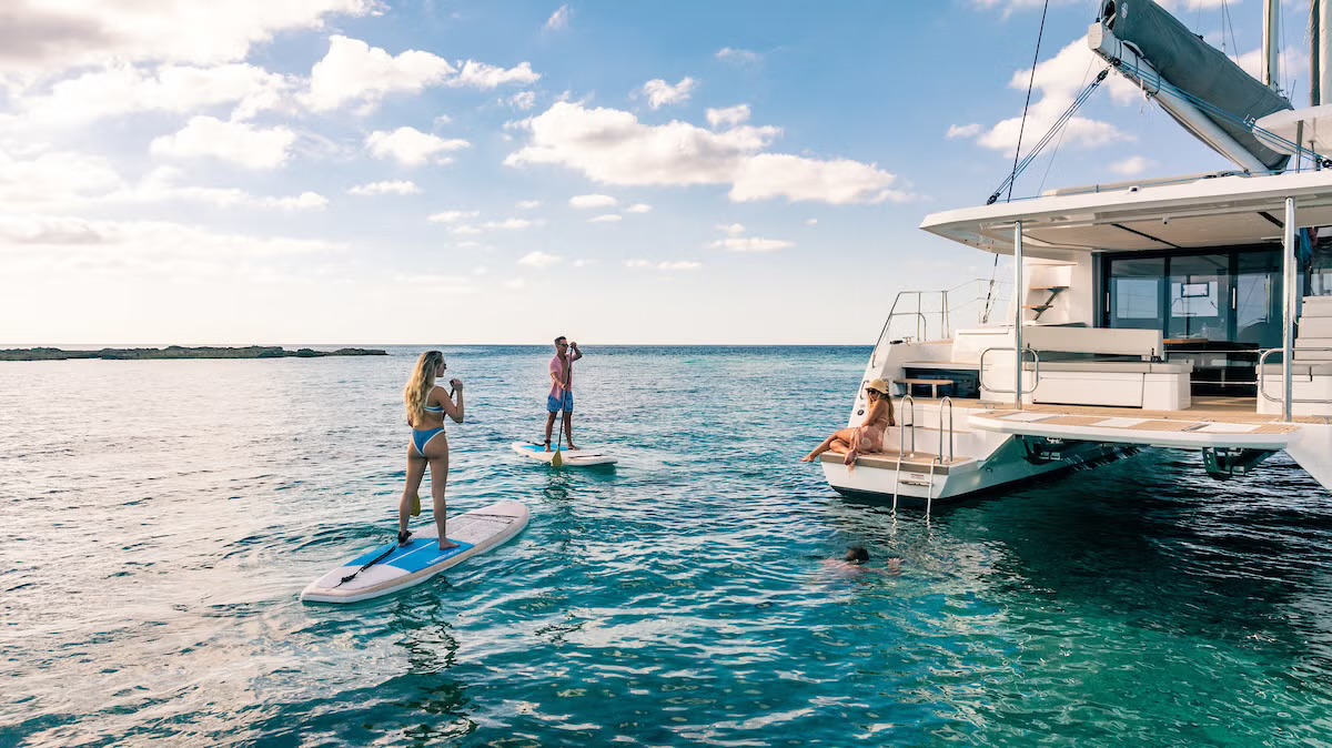 Leopard 46 swim platform with guests paddleboarding and swimming