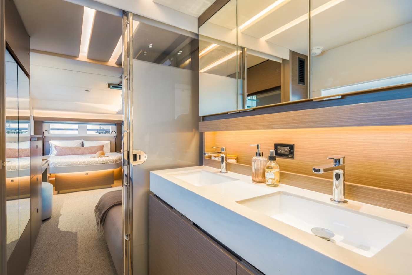 53PC master suite double bed facing the hull windows, with vanity and TV