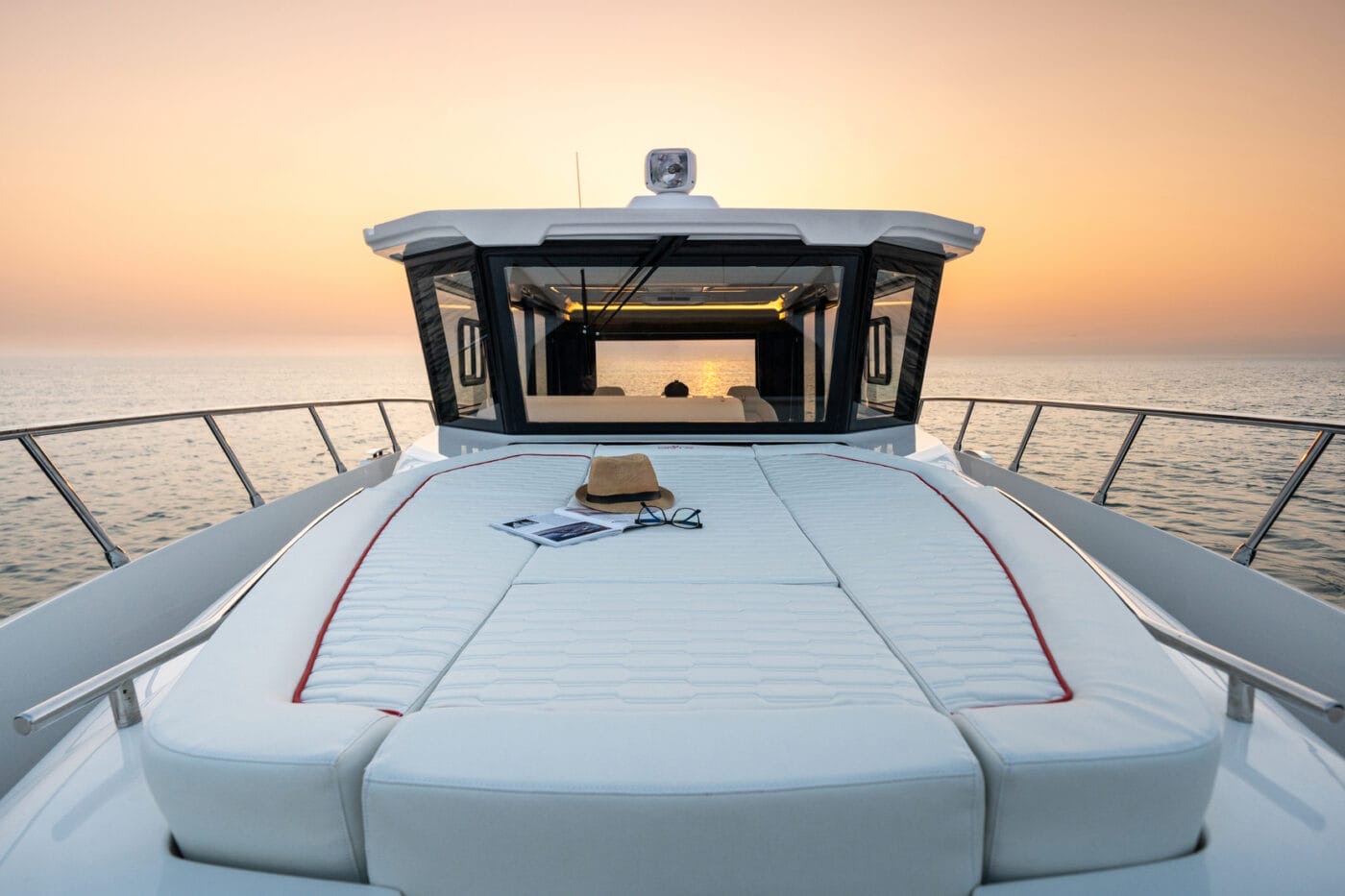 37LX foredeck sunpad and enclosed cockpit front at sunset