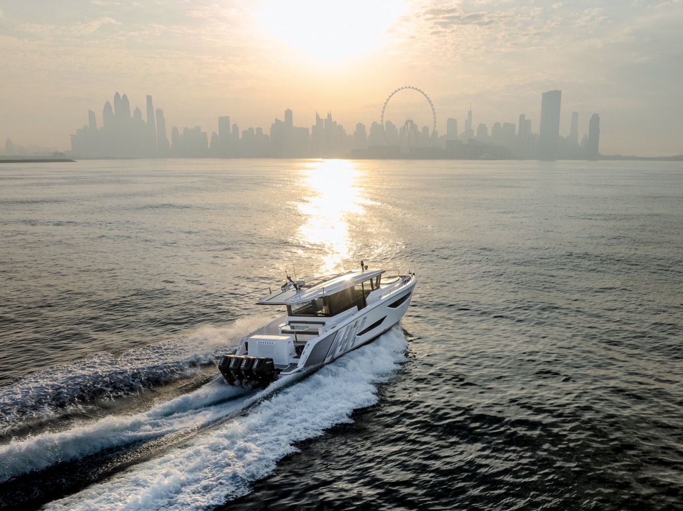Oryx 47LX running at speed on open blue water, carving a long wake