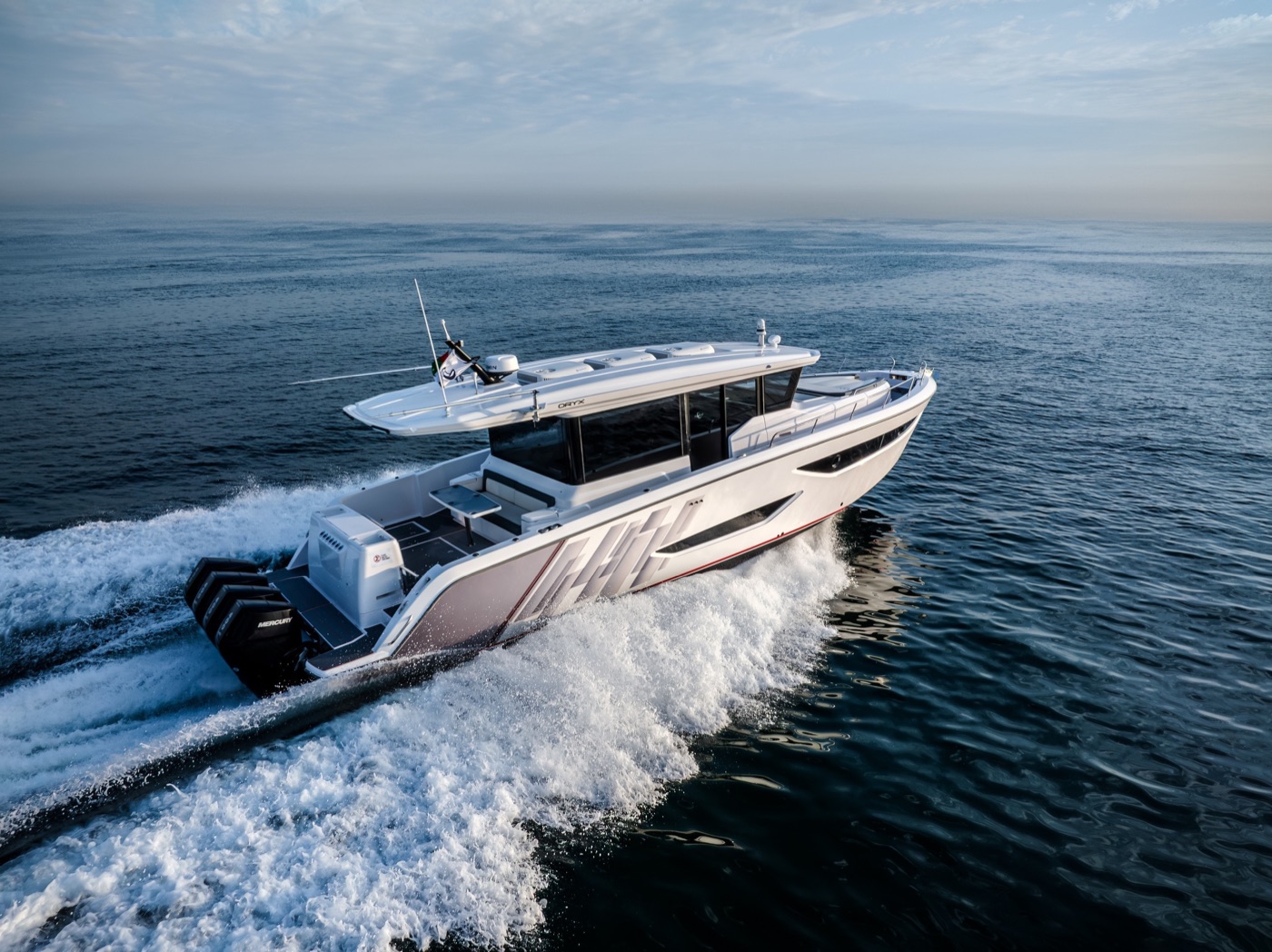 Oryx 47LX fully enclosed cockpit profile underway, quad outboards