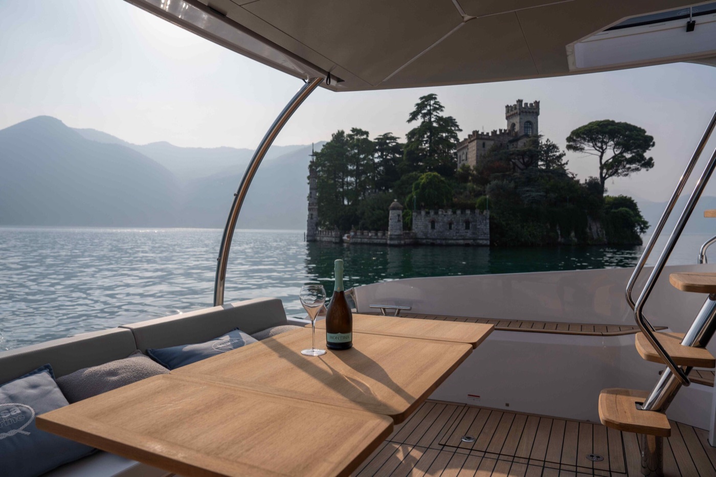 Sparkling wine on the cockpit table, an island castle beyond