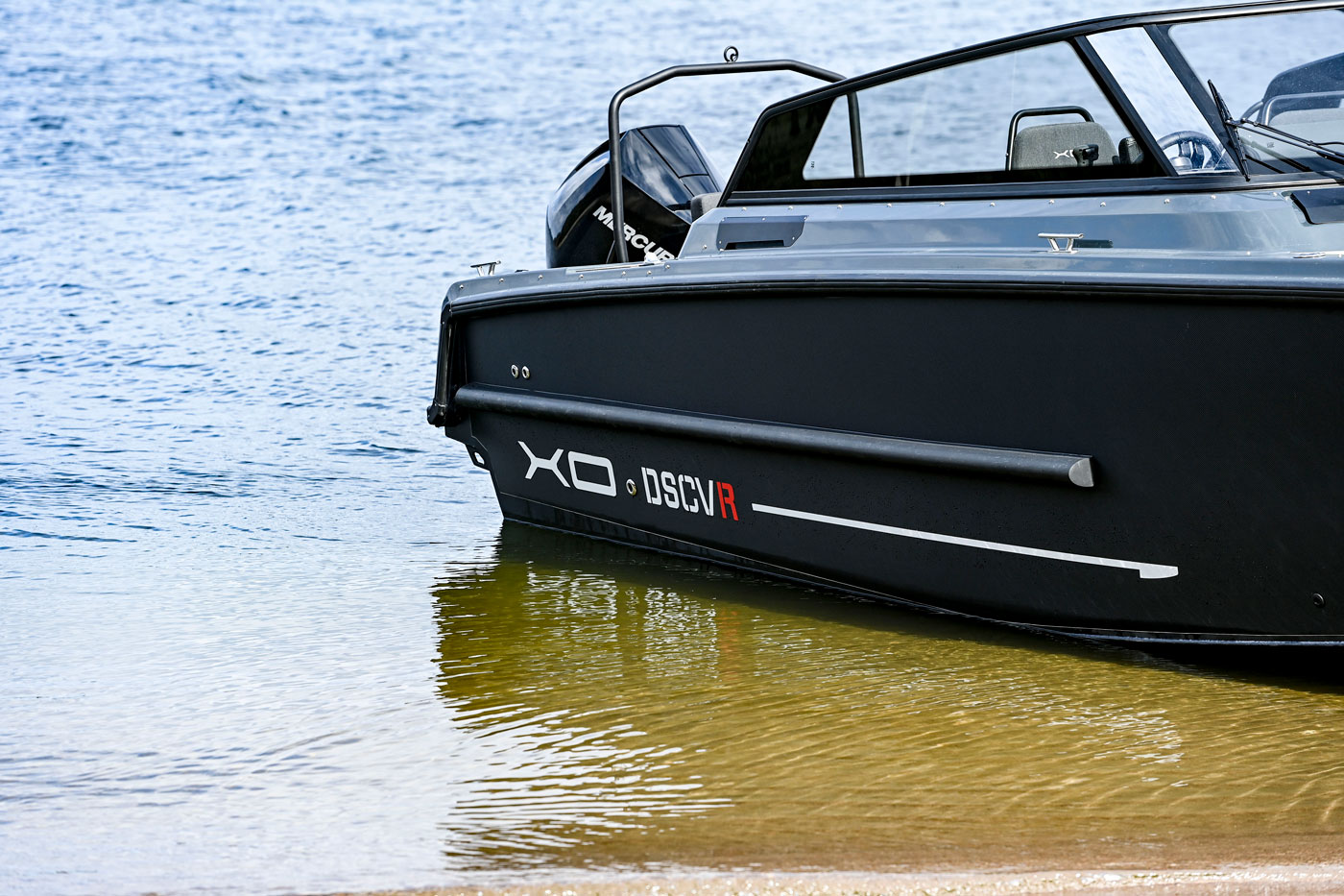 DSCVR 9 Open bow close-up with XO DSCVR branding in shallow water